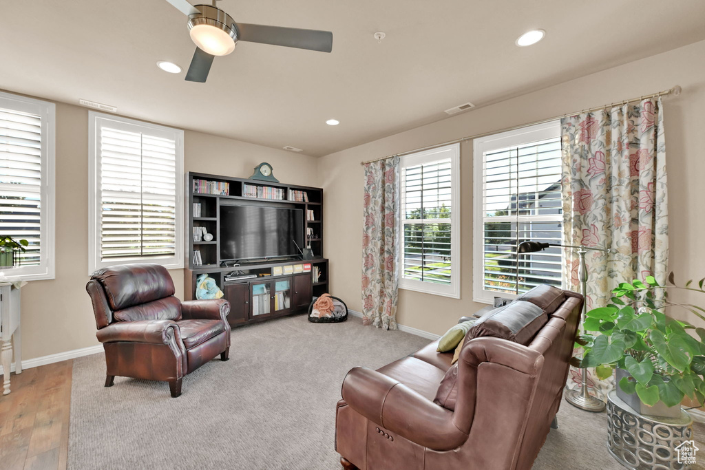 Living room with wood-type flooring and ceiling fan