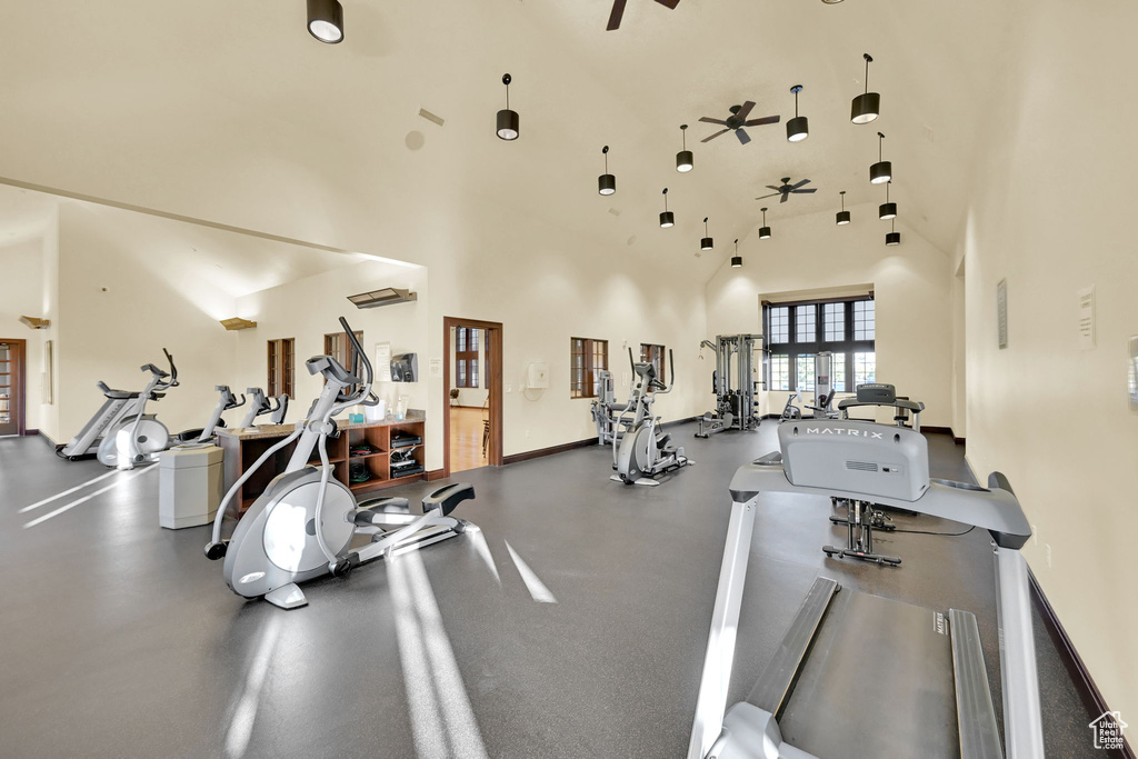 Gym featuring ceiling fan and high vaulted ceiling