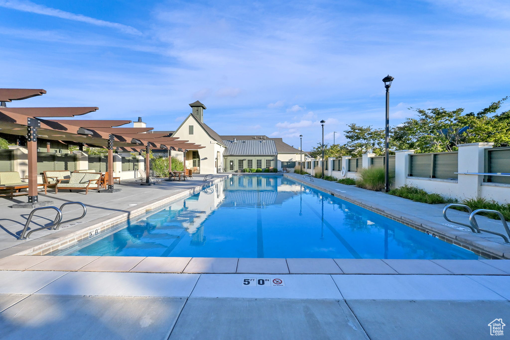 View of swimming pool with a pergola and a patio area