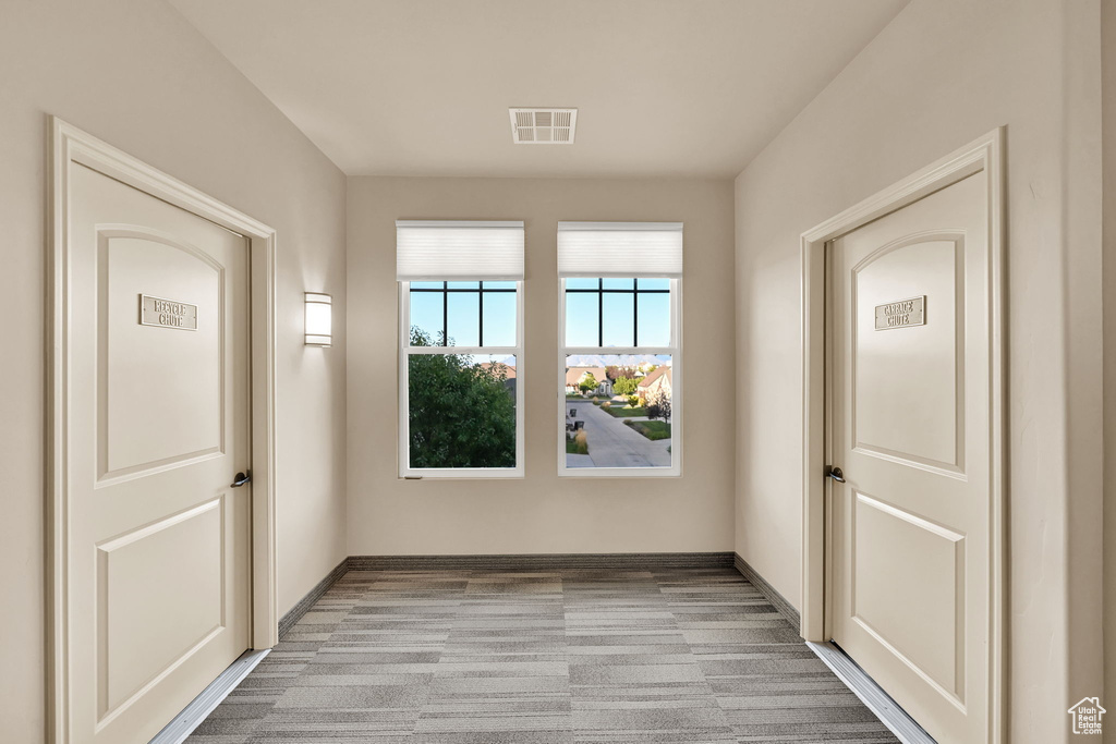 Unfurnished room featuring light carpet