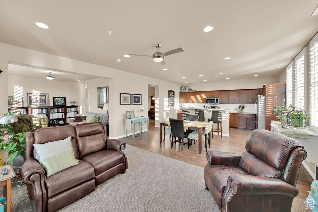 Living room featuring light hardwood / wood-style floors and ceiling fan