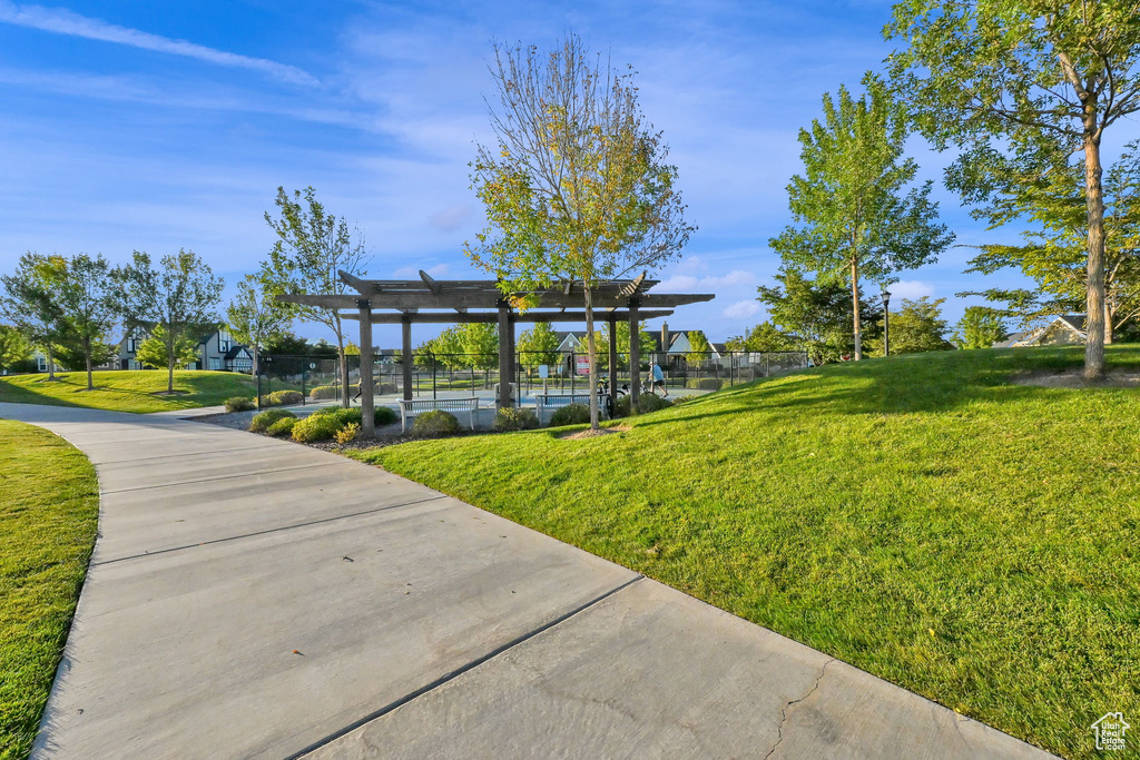 Surrounding community featuring a pergola and a yard