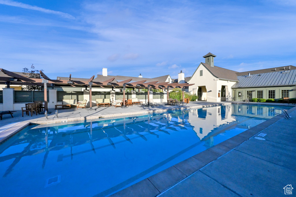 View of pool with a pergola and a patio area