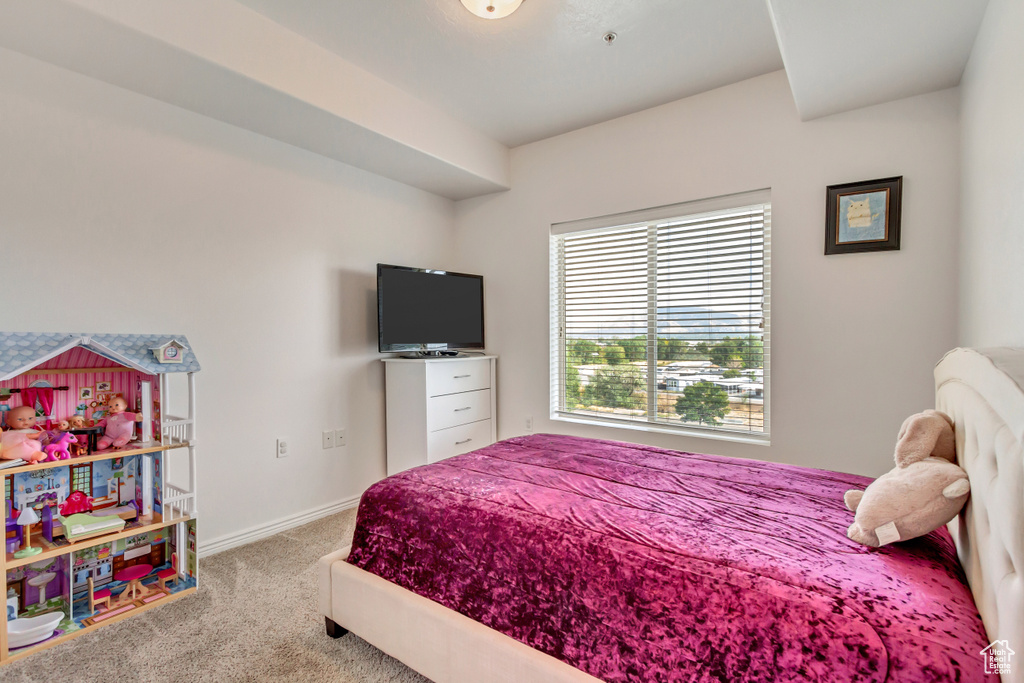 Bedroom featuring light carpet