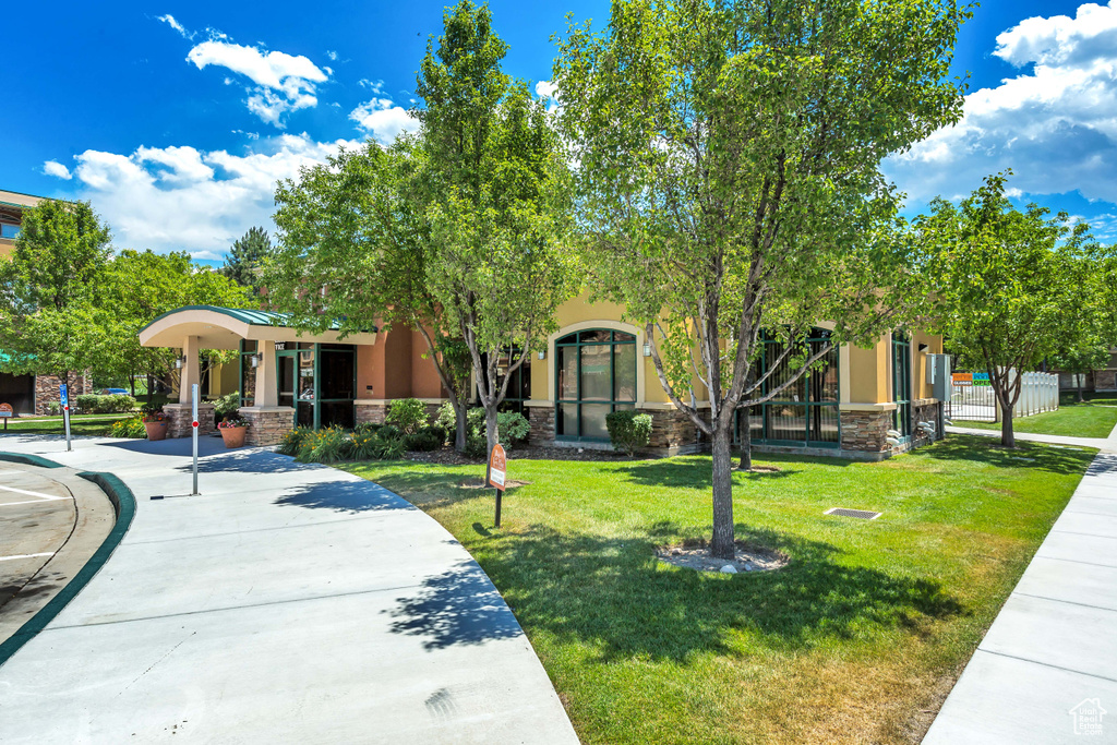 View of home's community with a lawn