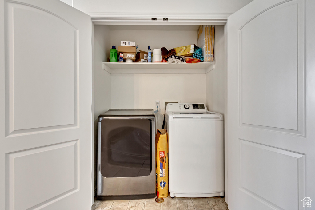 Clothes washing area featuring washer and clothes dryer