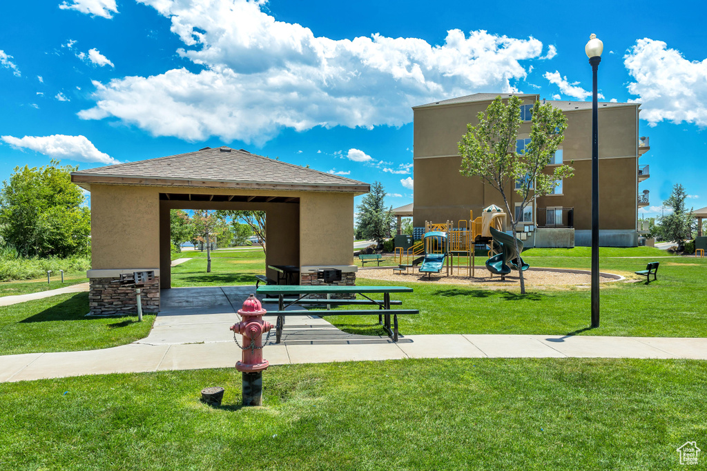 Surrounding community with a playground and a yard