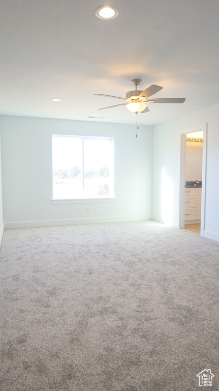 Spare room with ceiling fan and carpet floors