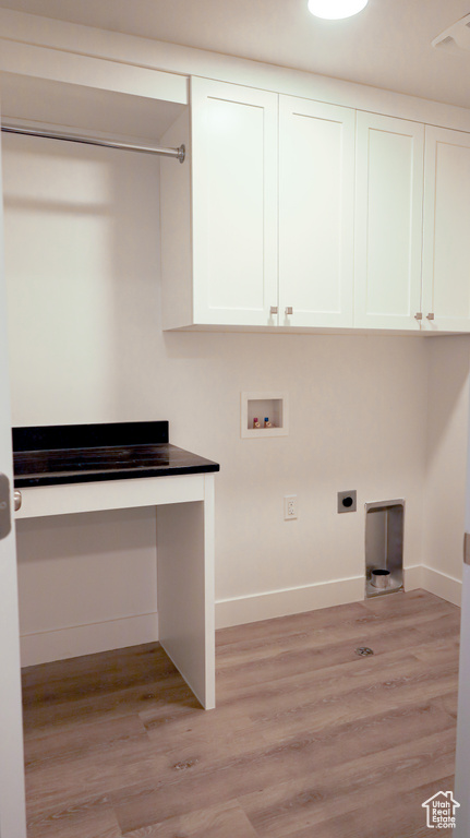 Laundry room featuring hookup for a washing machine, cabinets, electric dryer hookup, and light hardwood / wood-style flooring