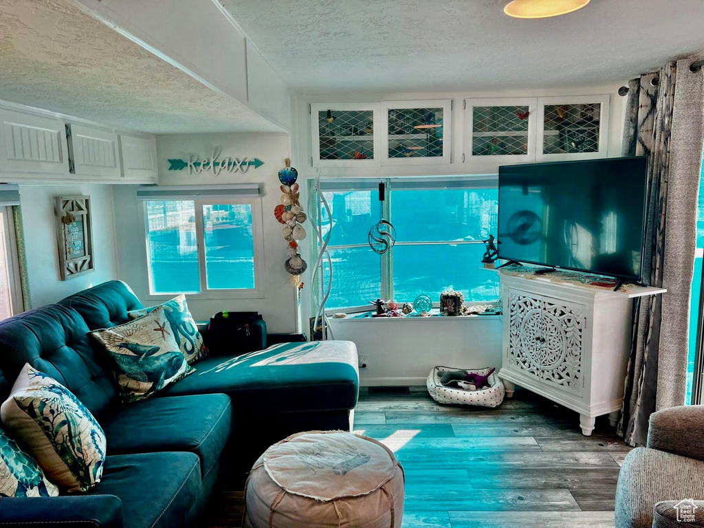 Living room featuring a textured ceiling and hardwood / wood-style flooring