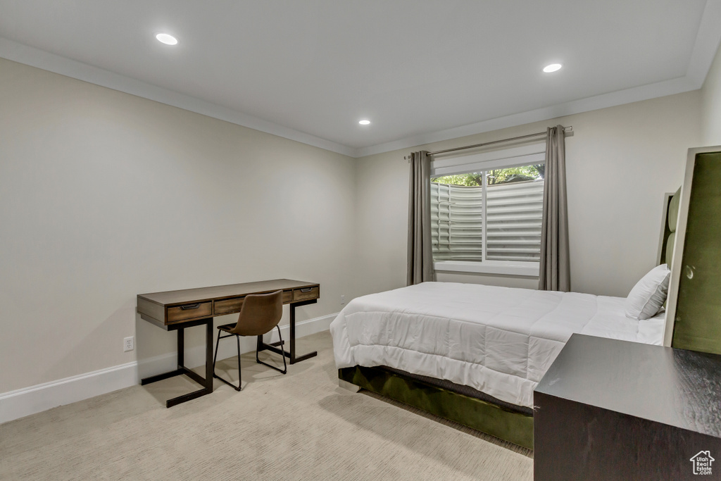 Carpeted bedroom with ornamental molding