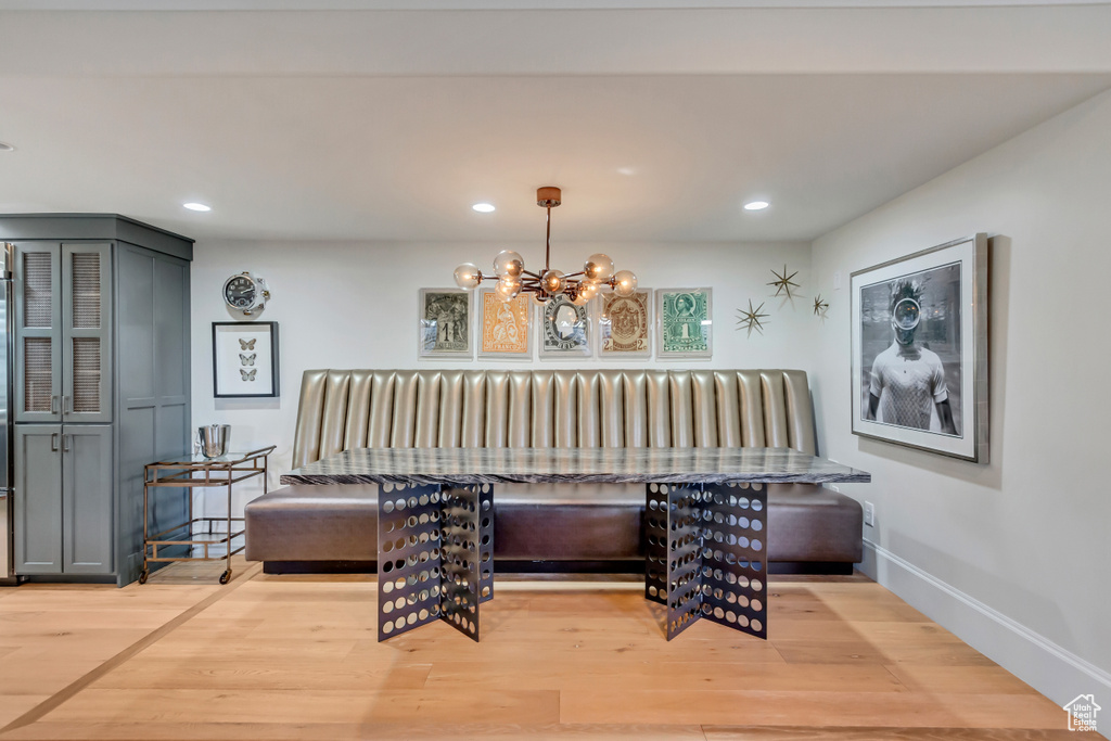 Dining room featuring a notable chandelier and light wood-type flooring