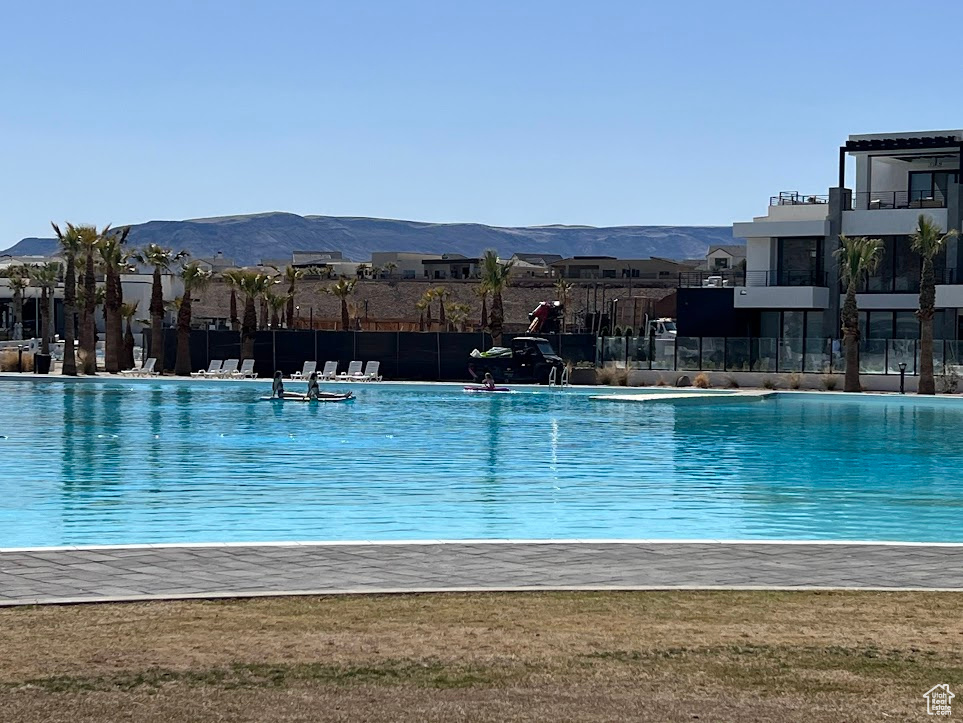 View of swimming pool with a mountain view