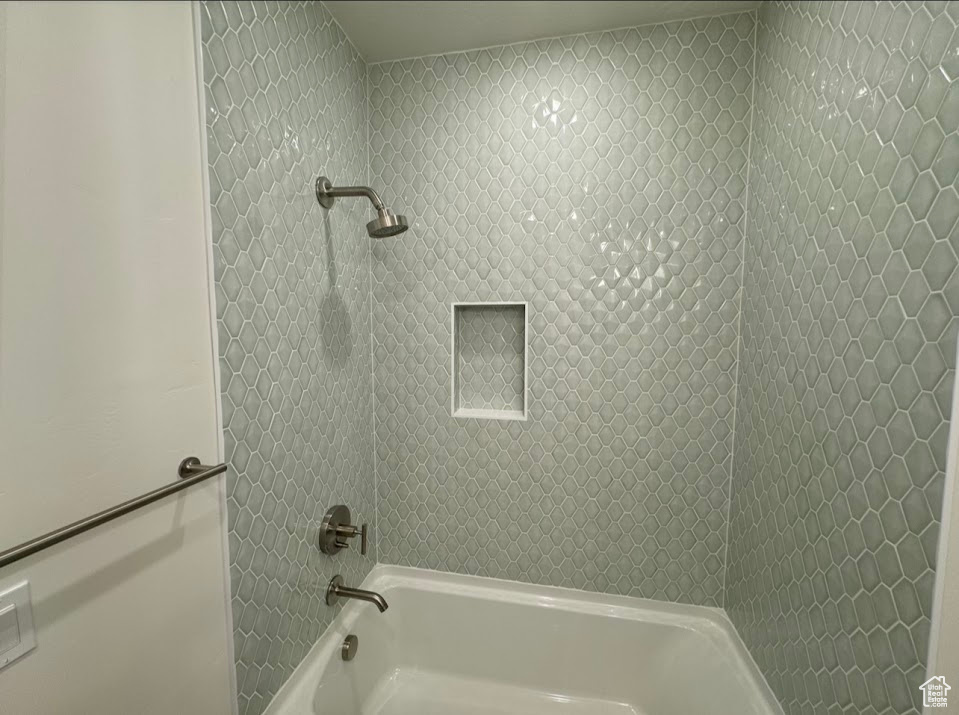 Bathroom featuring washtub / shower combination