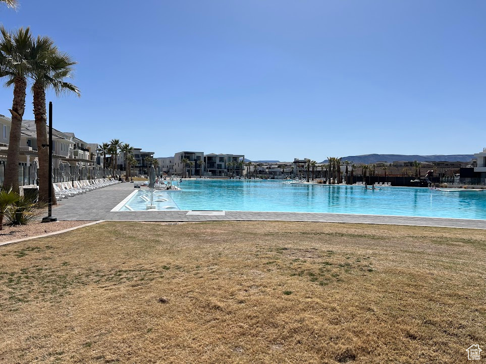 View of swimming pool with a yard