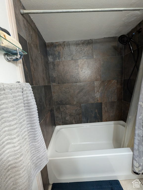Bathroom featuring shower / bath combo with shower curtain