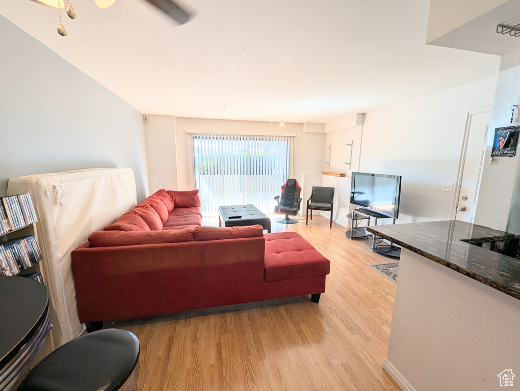 Living room featuring light wood-type flooring and ceiling fan