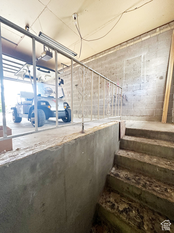 Staircase featuring concrete flooring