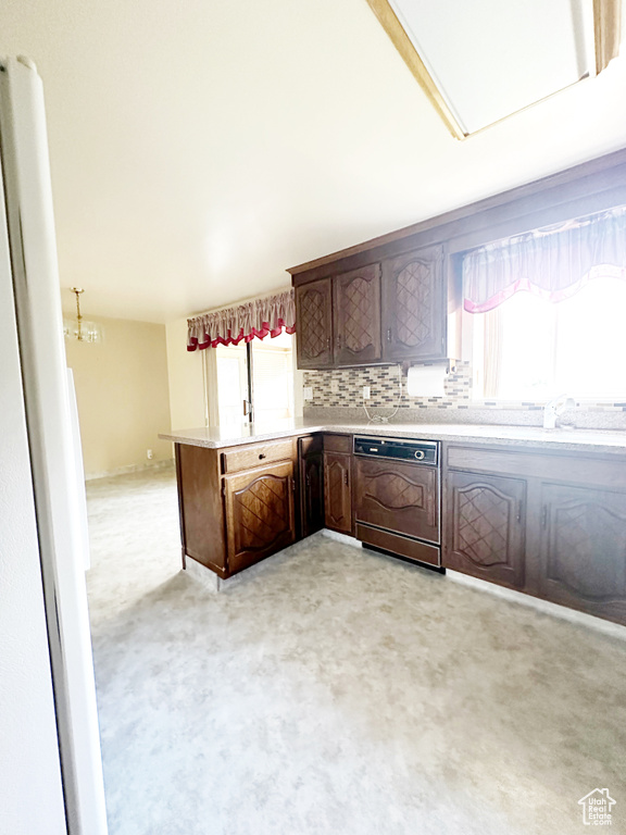 Kitchen with dark brown cabinetry, sink, backsplash, dishwasher, and light colored carpet