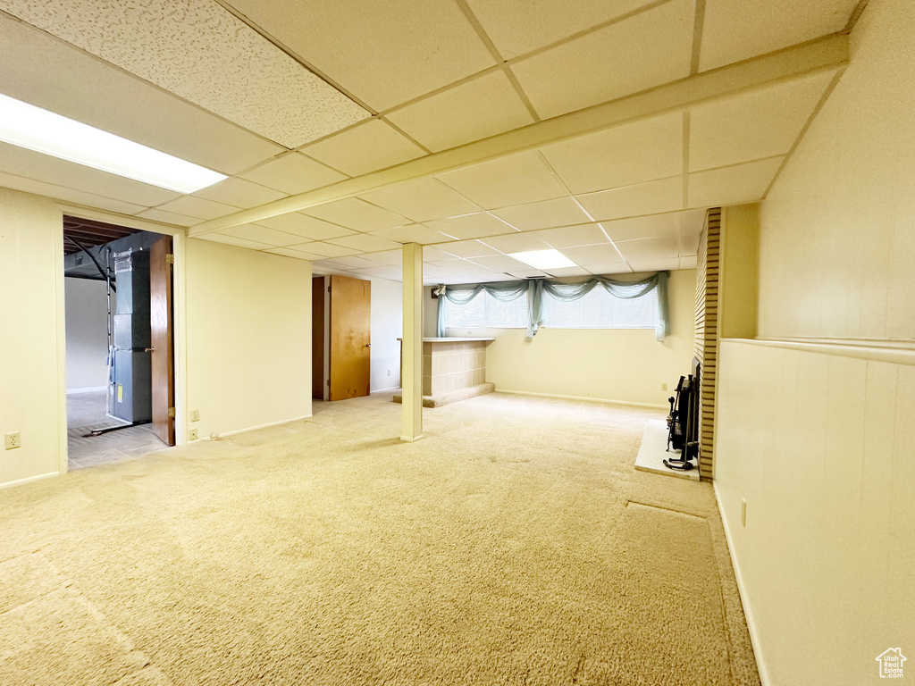 Basement with carpet floors and a drop ceiling