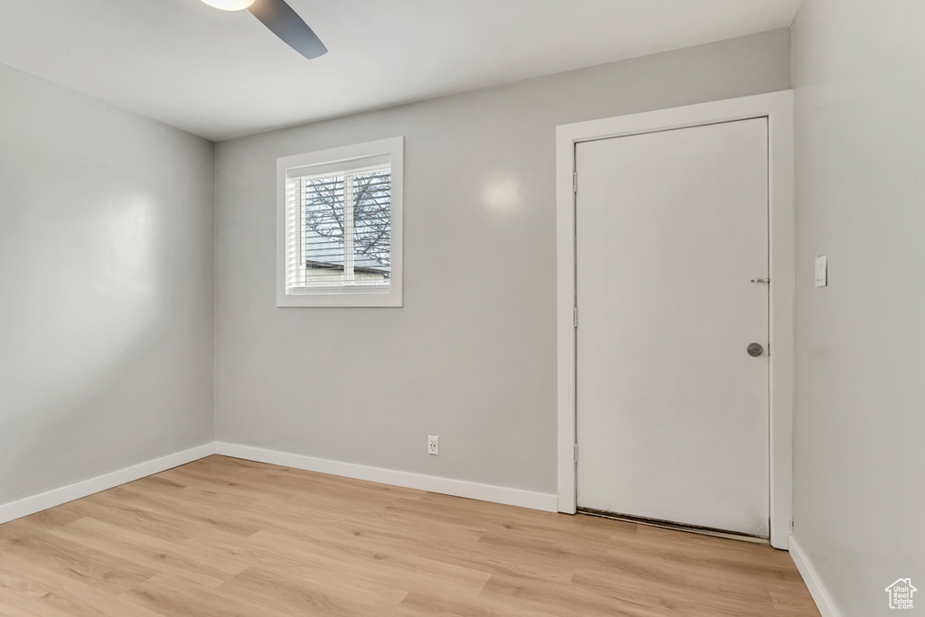 Empty room featuring ceiling fan and light hardwood / wood-style flooring