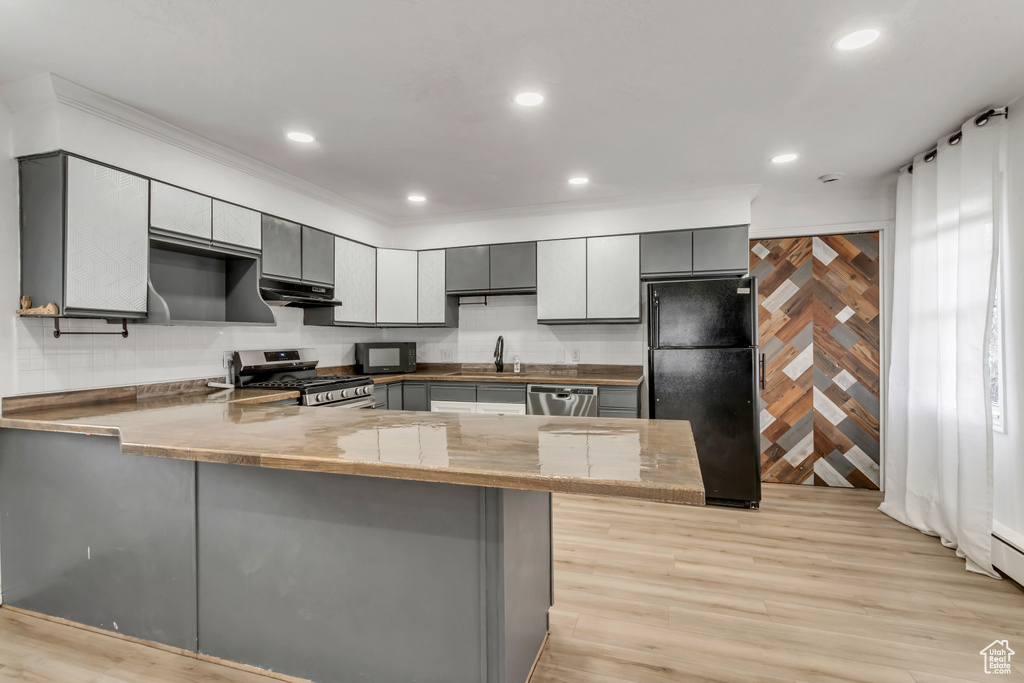 Kitchen featuring gray cabinets, light hardwood / wood-style floors, sink, kitchen peninsula, and black appliances