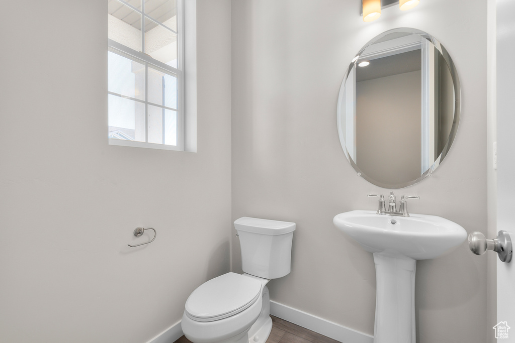 Bathroom featuring sink, hardwood / wood-style flooring, and toilet