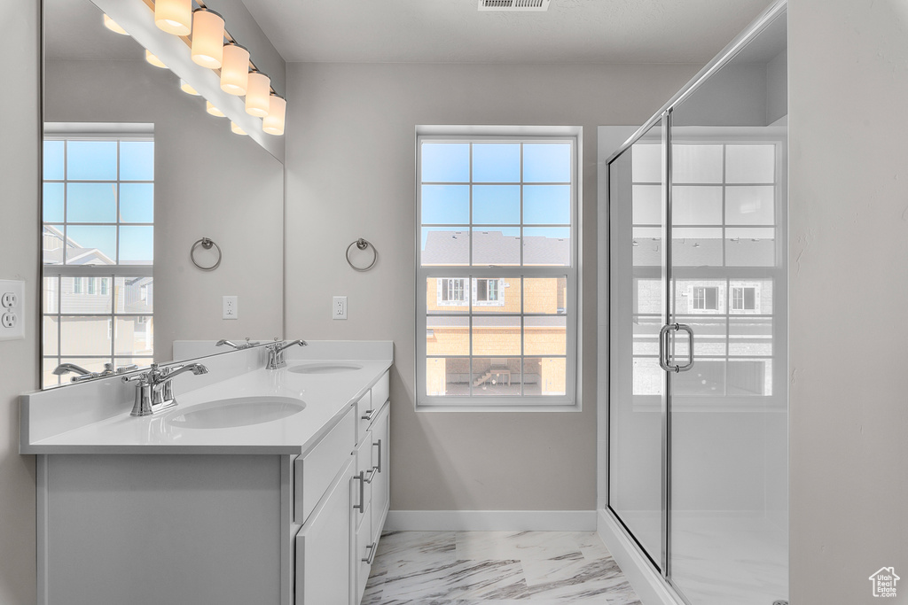 Bathroom featuring vanity and an enclosed shower