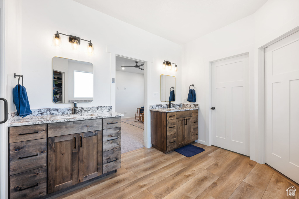 Bathroom with ceiling fan, vanity, and hardwood / wood-style floors