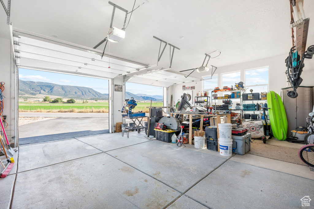 Garage with a garage door opener and a mountain view