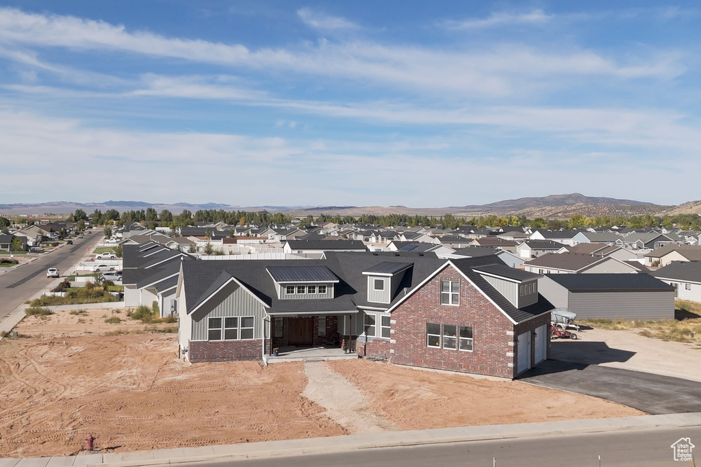 View of front of house featuring a mountain view and a garage