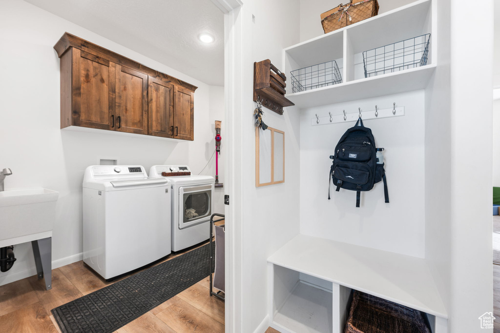 Interior space featuring cabinets, light hardwood / wood-style floors, and independent washer and dryer