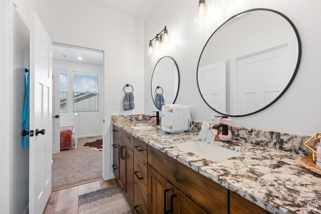 Bathroom featuring vanity and hardwood / wood-style floors