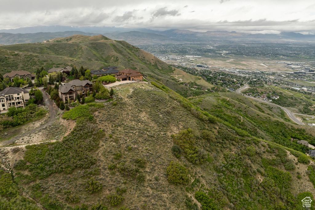 Aerial view of property and surrounding area featuring a mountainous background