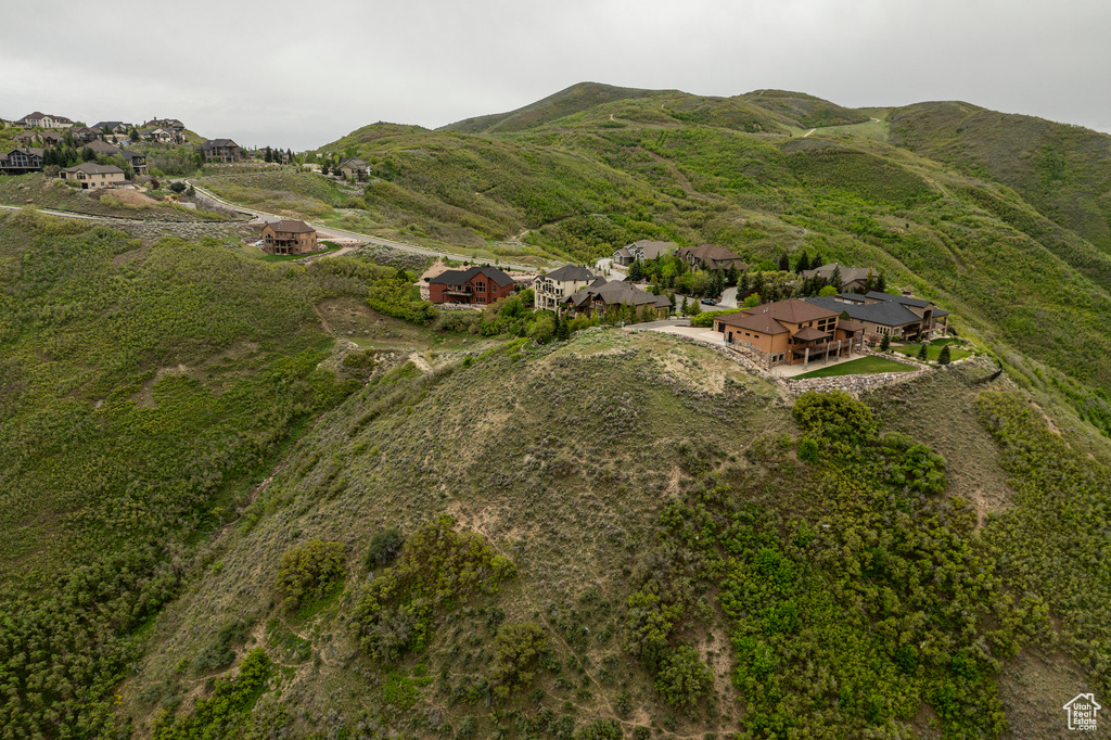 Aerial view of property's location featuring nearby suburban area and a mountain backdrop