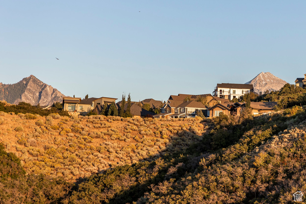 View of mountain backdrop featuring nearby suburban area
