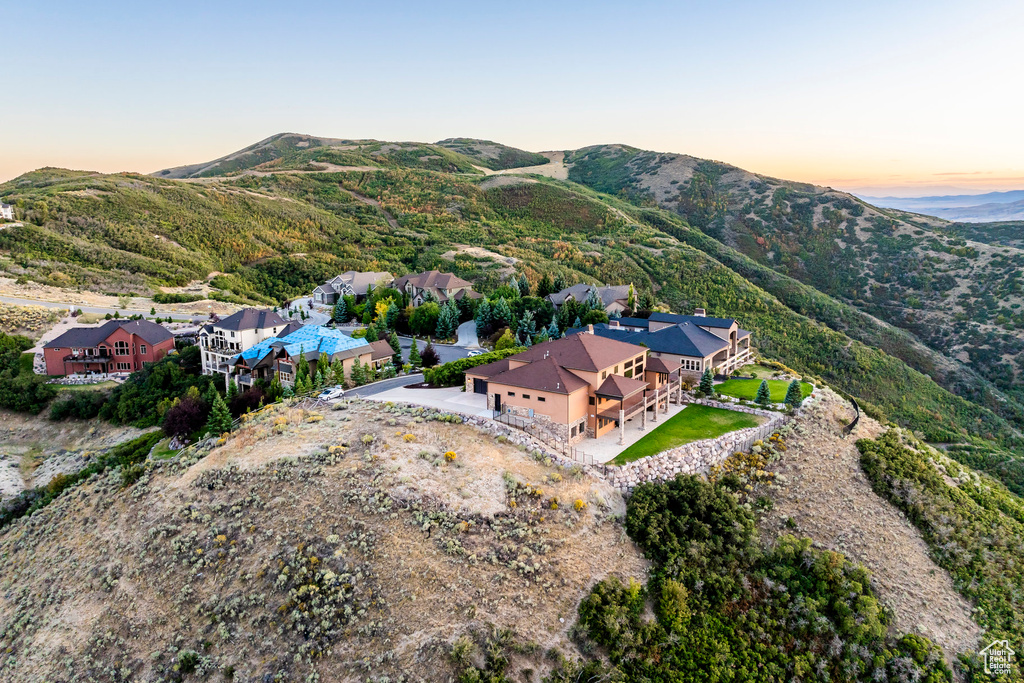 Aerial view of property's location featuring a mountainous background