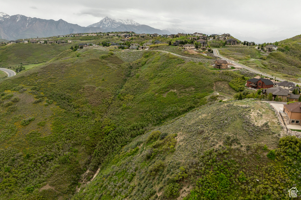 Aerial view of property's location featuring a mountainous background