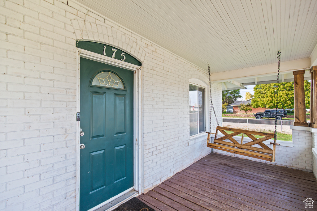 View of exterior entry featuring covered porch