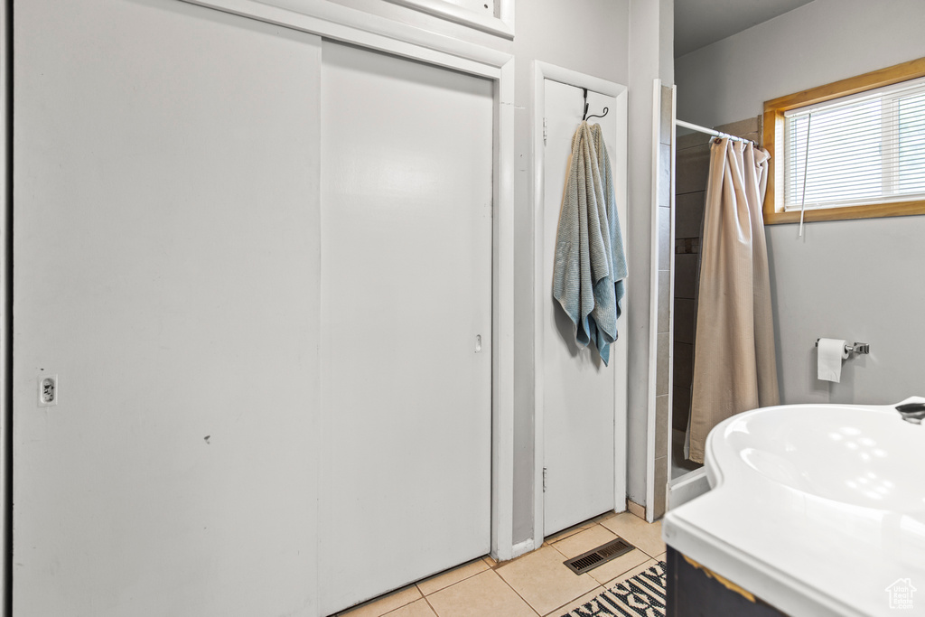 Bathroom featuring walk in shower and tile patterned floors