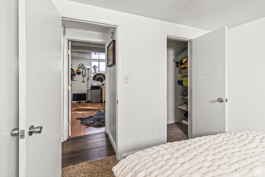 Bedroom featuring a closet and dark wood-type flooring