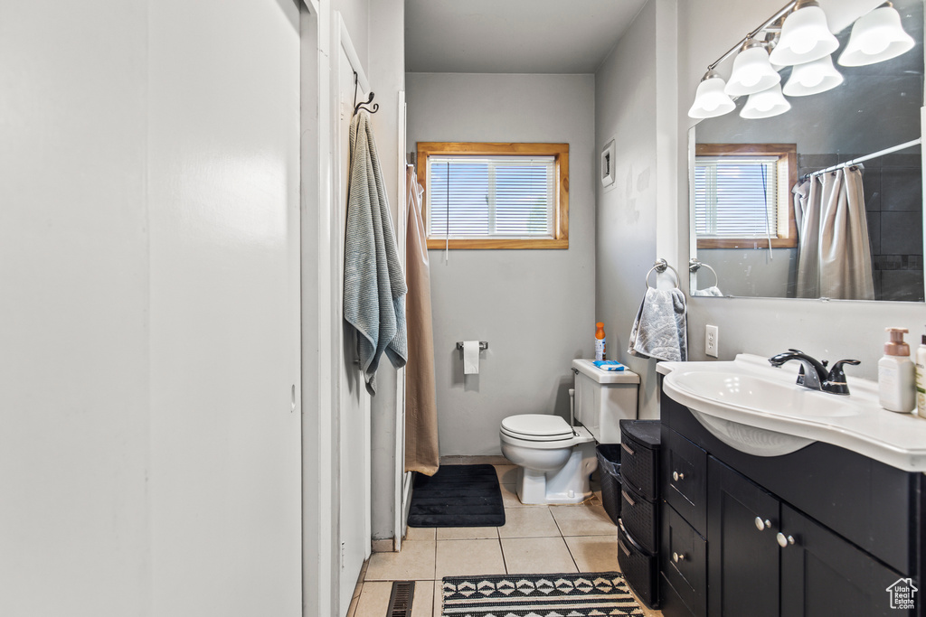 Bathroom with tile patterned flooring, vanity, and toilet