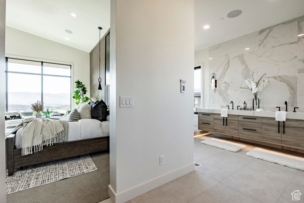 Bathroom with vanity and vaulted ceiling