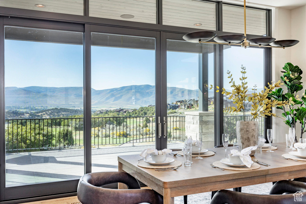 Dining area featuring wood-type flooring and a mountain view