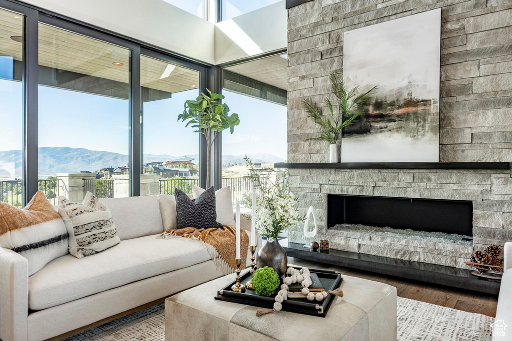 Living room with wood-type flooring, a fireplace, and a mountain view