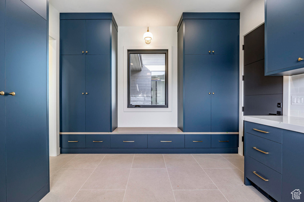 Mudroom with light tile patterned flooring