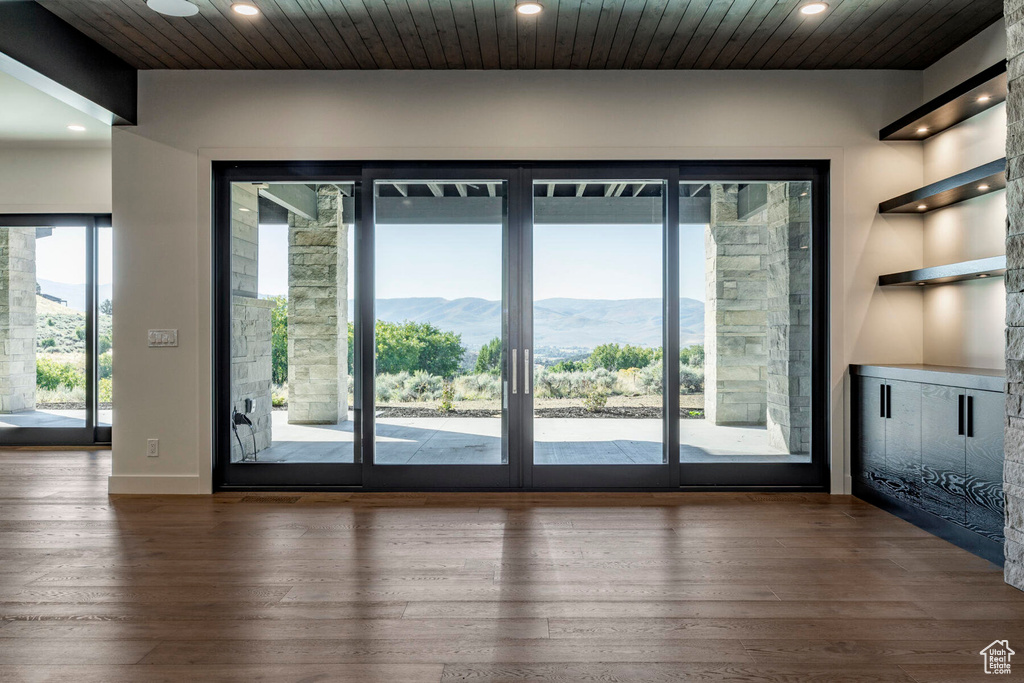 Doorway with wood-type flooring, wood ceiling, and a mountain view