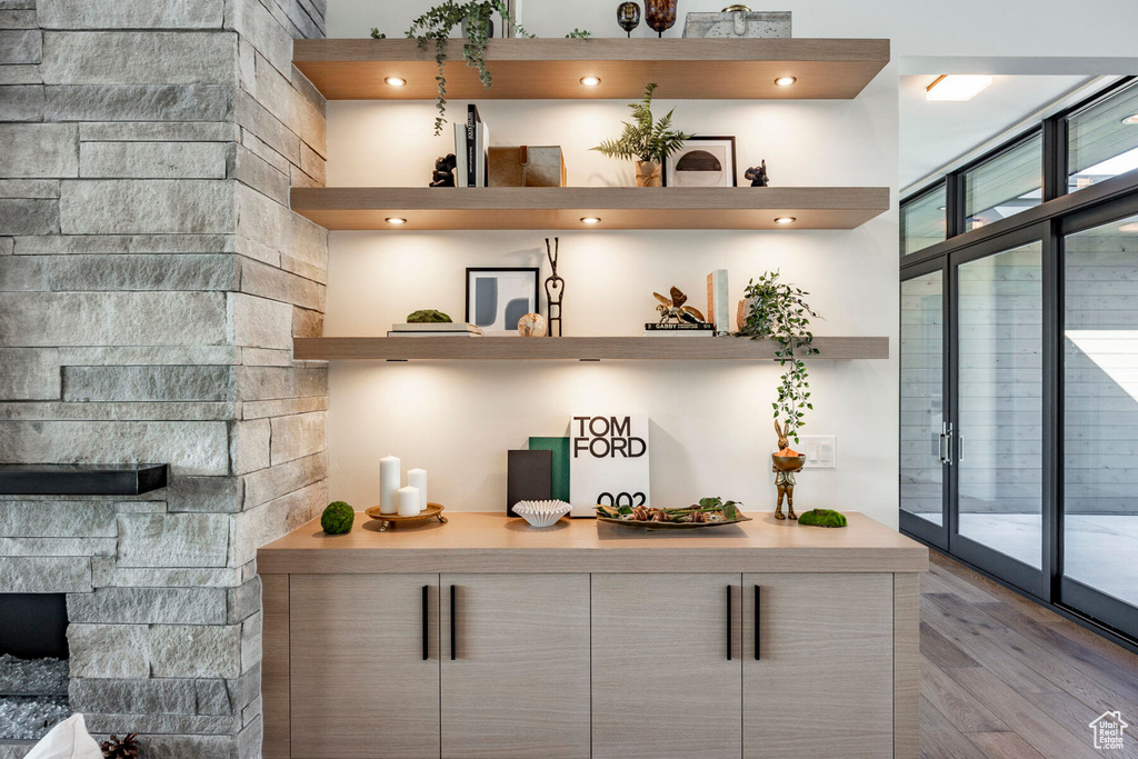 Bar featuring light wood-type flooring and floor to ceiling windows