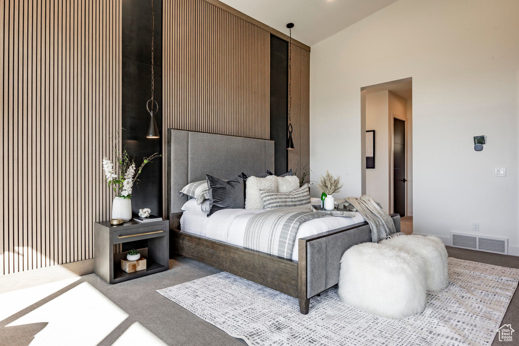 Carpeted bedroom featuring lofted ceiling