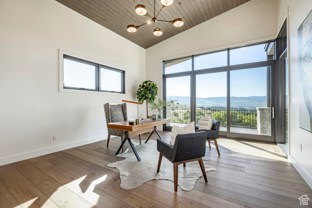 Interior space featuring wooden ceiling, light hardwood / wood-style floors, an inviting chandelier, and a mountain view